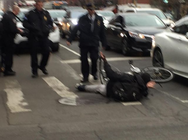 An NYPD officer shoves a bicyclist off his bike to give him a ticket, according to a witness.